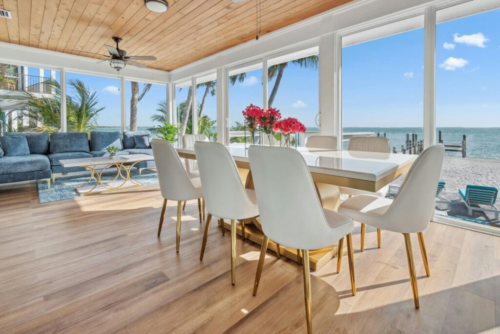 Bright and modern beachfront room with ocean view featuring elegant decor and natural light.